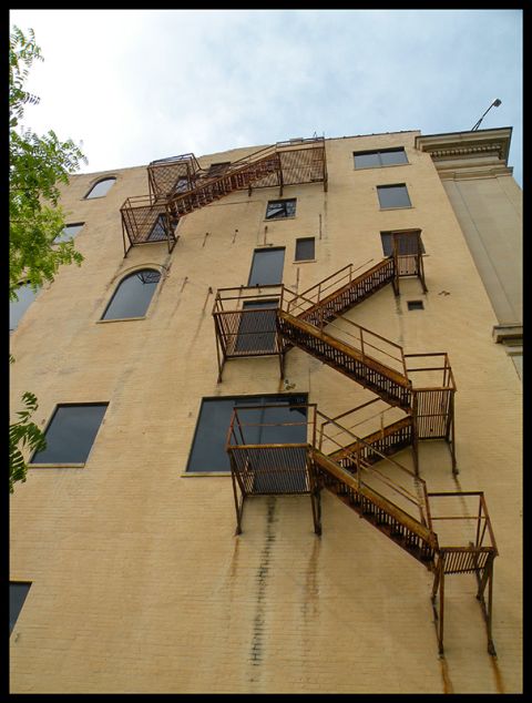 1998 Subaru Legacy - An external metal fire escape system zigzags down the side of a building.