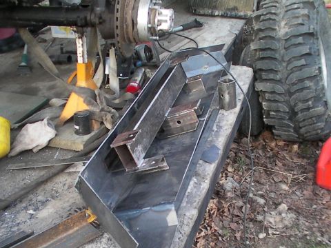 1987 Suzuki Samurai - Fabrication of a custom bumper is underway, with raw metal components and vehicle parts visible.