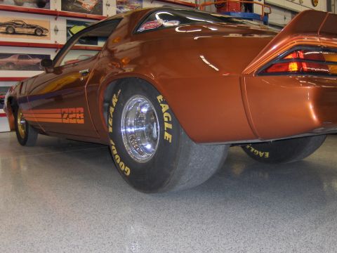 1979 Chevrolet Camaro - This 1979 Chevrolet Camaro features a distinctive orange paint job and wide drag racing tires.