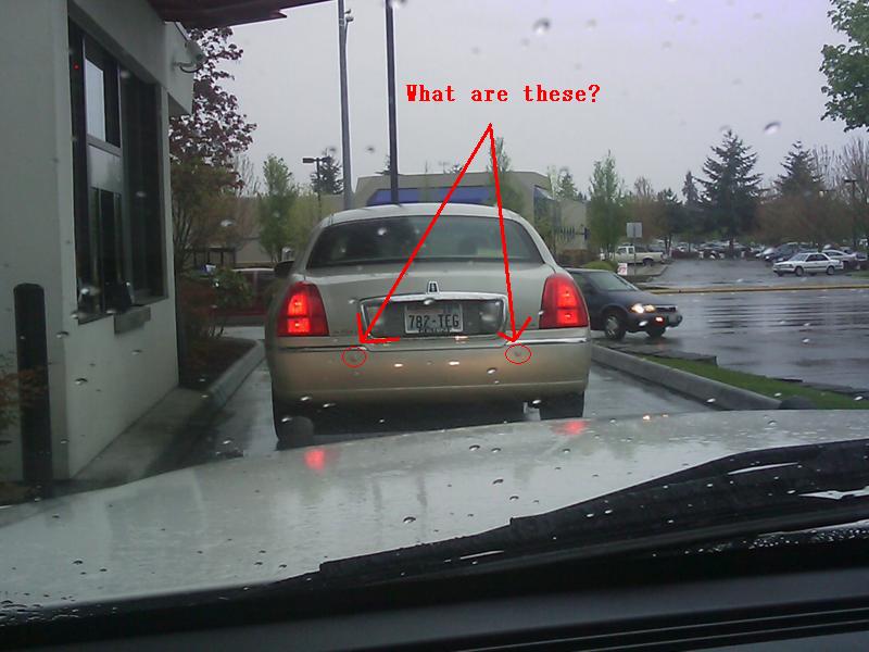 Gold sedan rear with license plate 78Z-TEG and red taillights. Another car is visible in the background