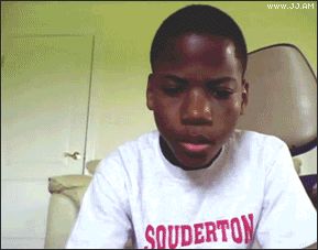 2000 Mercury Grand Marquis - A young boy is shown from the chest up, wearing a white t-shirt with some text on it.