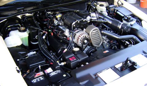 1996 Mercury Grand Marquis - Close-up view of a supercharged engine bay, showing various components and wiring.