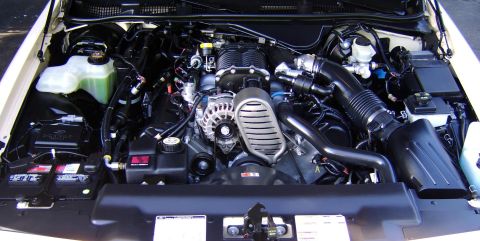1996 Mercury Grand Marquis - Close-up view of a supercharged engine bay, showing various components.