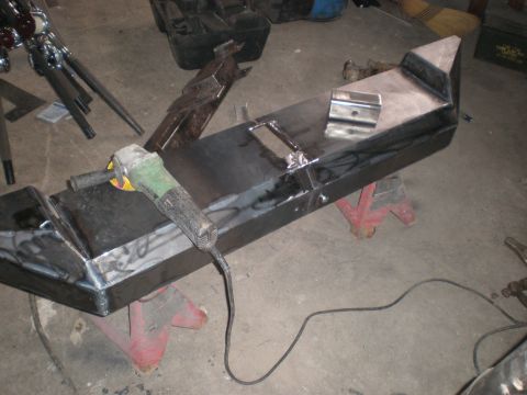 1987 Suzuki Samurai - Fabricating a custom bumper with an angle grinder in a workshop setting.