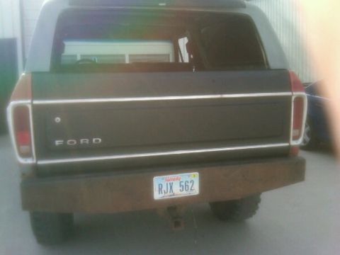 1987 Ford Bronco - The rear of a Ford Bronco shows its distinctive body style and a custom bumper.