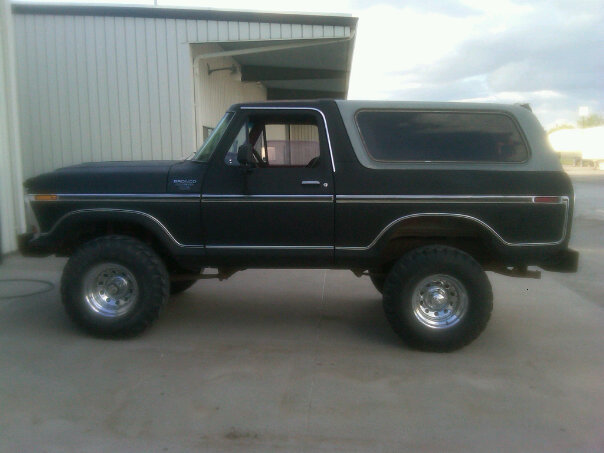 Side view of a black and grey 1978 Ford Bronco with chrome trim and large tires