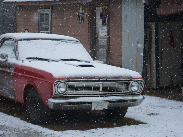1966 Ford Ranchero front end in snow, showing grille and Ford badge