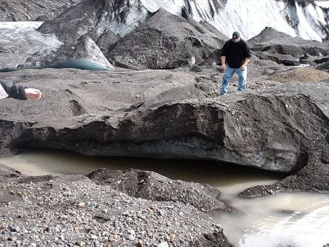 1996 Ford Bronco - Two individuals explore a glacial landscape dark moraine and pools of meltwater.