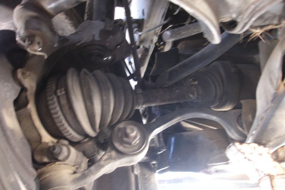 Close-up of a CV axle boot and suspension components