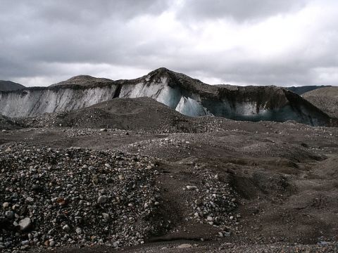 1996 Ford Bronco - A vast glacial landscape with ice formations visible behind rocky debris and hills.