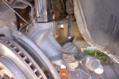 1992 Ford Taurus - Close-up view of a vehicle's front suspension system, including the brake rotor and tie rod end.