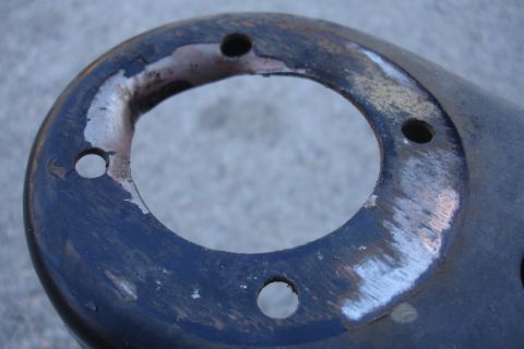 1992 Ford Taurus - A worn automotive part with visible signs of damage and rust, suggesting it is not new.