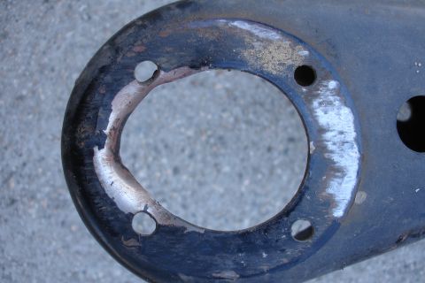 1992 Ford Taurus - This is a close-up view of a worn metal component with visible bolt holes and chipped paint.