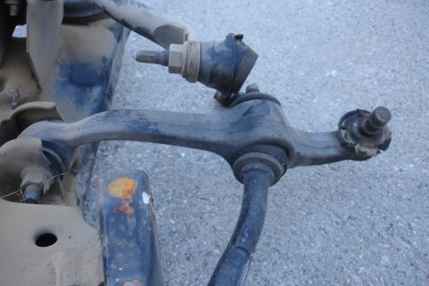 1992 Ford Taurus - Close-up view of automotive suspension components, including a control arm and ball joint.