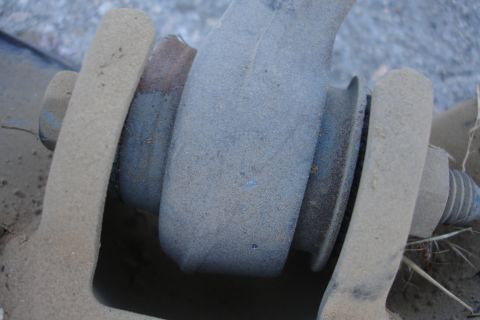 1992 Ford Taurus - A close-up view of a vehicle's suspension component, covered in dust.