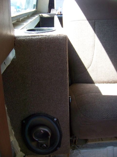 1989 Ford Bronco - Custom speaker box with integrated cup holder installed in the interior of a vehicle.