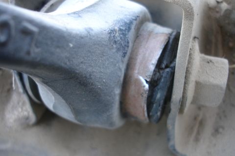 1992 Ford Taurus - Damaged suspension bushing showing wear and tear on the rubber component.