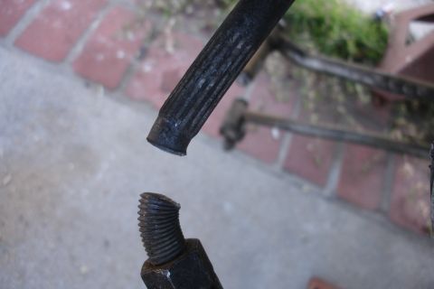 1992 Ford Taurus - Close-up of a broken metal rod with a threaded end, suggesting a mechanical failure.
