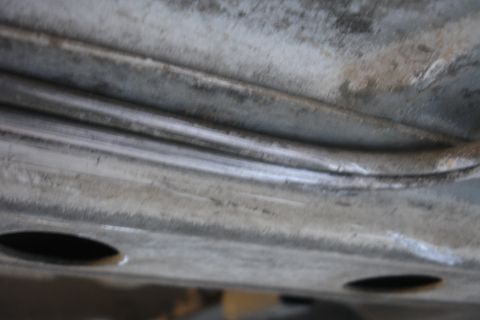 1992 Ford Taurus - Underside view of a vehicle's subframe, showing metal structure and some wear.