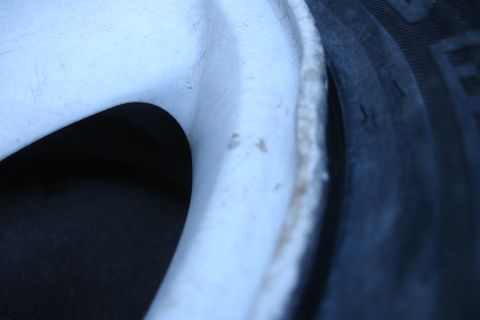 1992 Ford Taurus - Detail of a vehicle's wheel and tire, likely showing wear or damage related to subframe replacement.