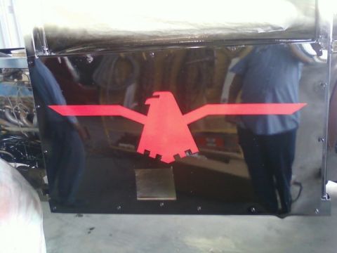 1996 Ford Bronco - A black panel features a prominent red eagle emblem and the 'SUPERMOTORS' logo at the bottom.