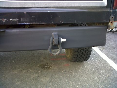 1986 Ford Bronco - Close-up of a vehicle's rear bumper and tow hook assembly.
