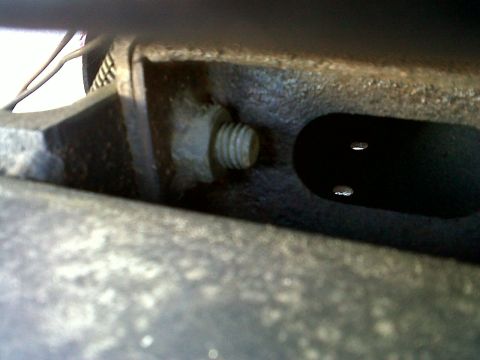 1986 Ford Bronco - A close-up view of a bolt and some metal components, possibly from an engine.