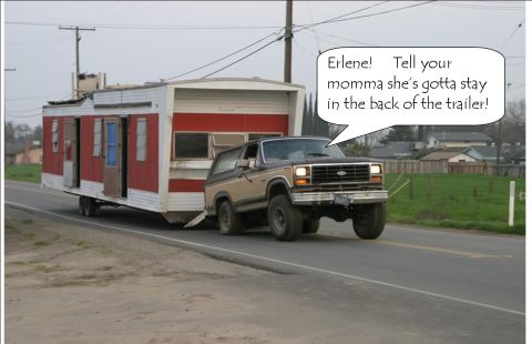 1990 Ford Bronco - Ford Bronco tows a trailer down a rural road.