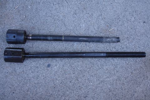 1992 Ford Taurus - Two tie rod ends are shown laid out on a gray surface, likely for comparison or replacement.