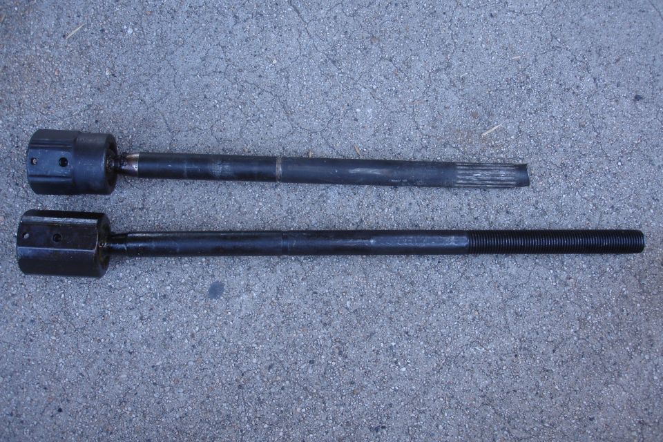 Two tie rod ends on a gray surface