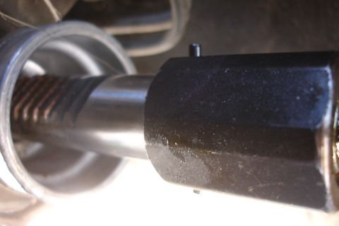 1992 Ford Taurus - A close-up view of a vehicle's steering rack and pinion assembly, showing mechanical components.