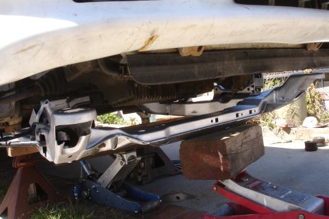 1992 Ford Taurus - Vehicle subframe being replaced, supported by jack stands and wooden blocks.