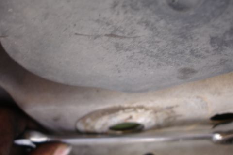 1992 Ford Taurus - A close-up view of a vehicle's underbody, possibly related to subframe work, with a tool visible.