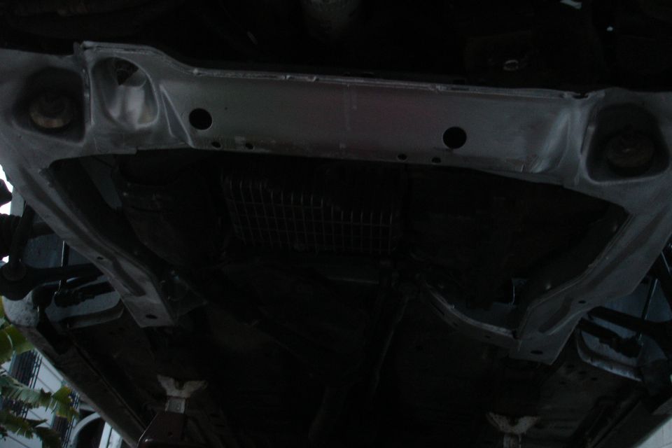 Underbody subframe with visible repair work