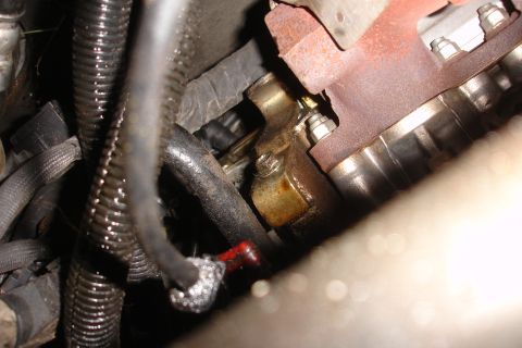 1992 Ford Taurus - Engine bay detail showing hoses and exhaust manifold connection.