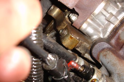1992 Ford Taurus - A close-up view of engine components, showing oil and grime.