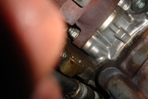 1992 Ford Taurus - Close-up view of an engine component, showing a bolt and surrounding metal parts.