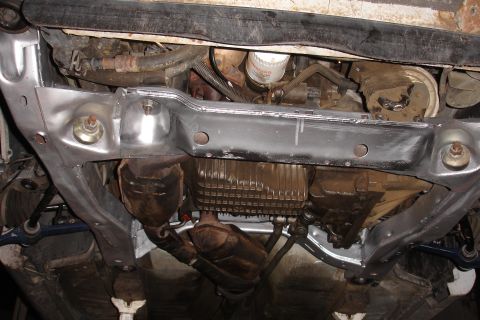 1992 Ford Taurus - Underside view of a vehicle's engine, transmission, and subframe components, possibly during repair.