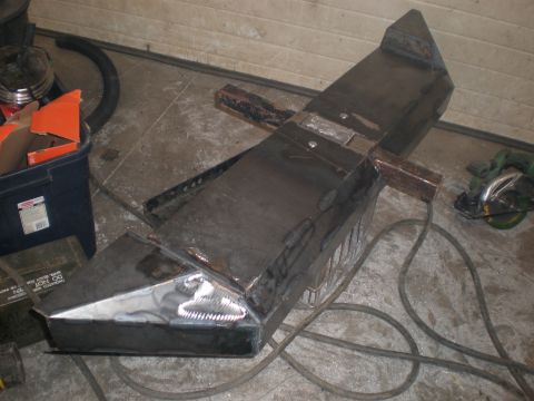 1987 Suzuki Samurai - Fabricated metal bumper sits on a workshop floor, ready for installation.
