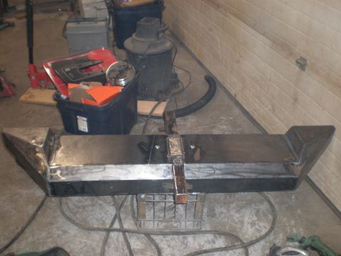 1987 Suzuki Samurai - A custom-welded bumper sits in a garage, surrounded by tools and equipment.