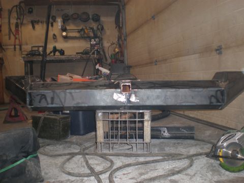 1987 Suzuki Samurai - Unfinished custom metal bumper with a receiver hitch opening sits on a metal crate in a workshop.
