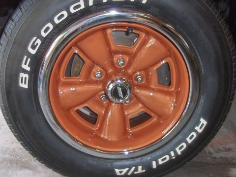 1980 Chevrolet Camaro - Close-up of a vehicle's wheel and tire, showing the orange painted rim and tire sidewall details.