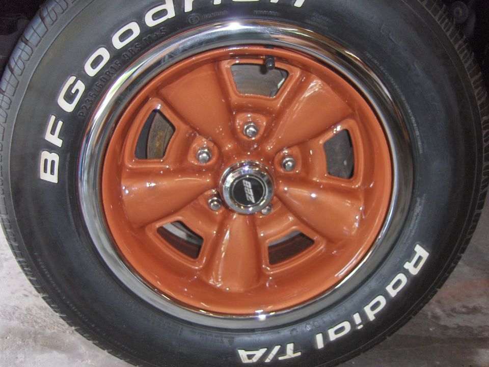 Orange five-spoke wheel with chrome trim and BFGoodrich Radial T/A tire