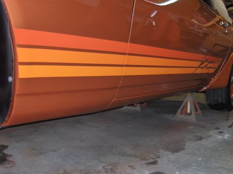 1980 Chevrolet Camaro - This 1980 Chevrolet Camaro features distinctive orange and brown racing stripes along its side.