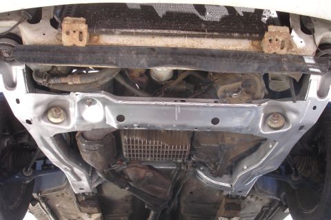 1992 Ford Taurus - Underside view of a car's subframe and engine components, possibly after a repair.
