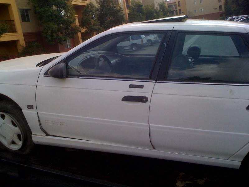 1992 Ford Taurus station wagon, side view, white paint, sunroof open