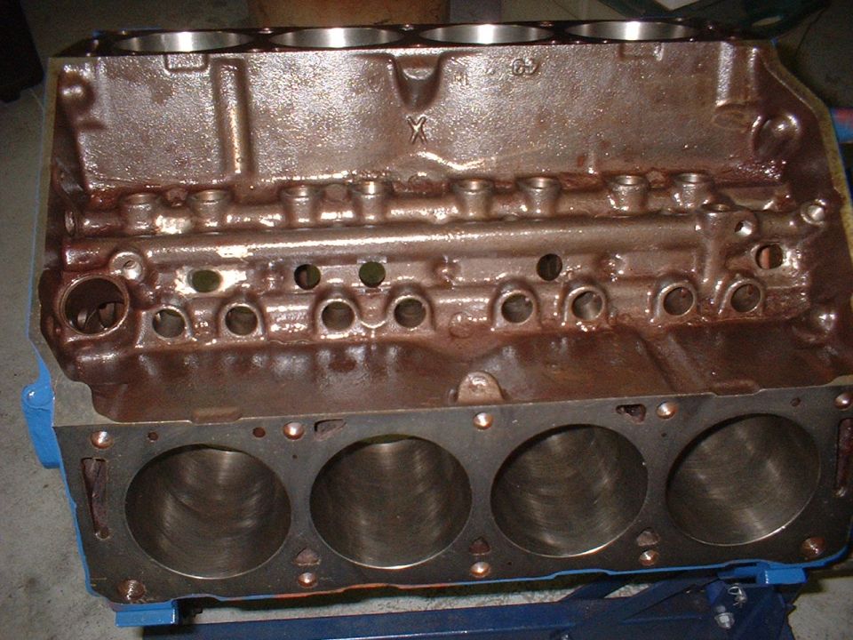 Engine block with cylinder bores visible, some casting marks on top