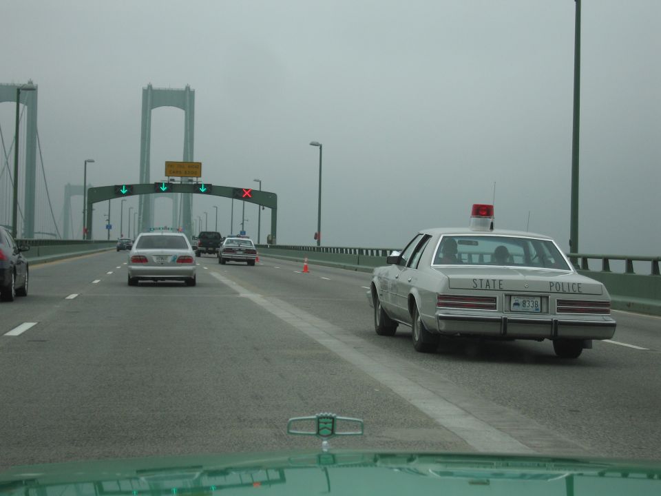 Silver State Police sedan on a foggy suspension bridge highway