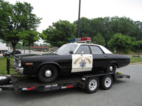 1991 Ford Crown Victoria - This 1977 Dodge Monaco police car, marked "Highway Patrol", is shown on a trailer.
