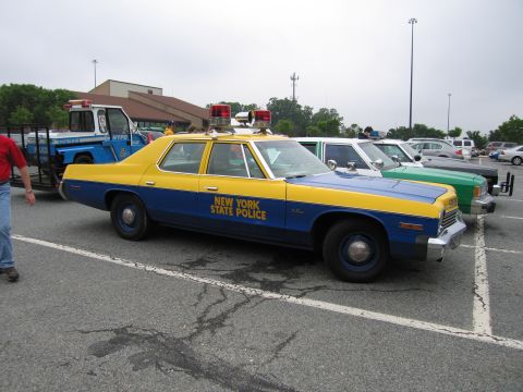 1991 Ford Crown Victoria - A vintage New York State Police car is parked in a lot with other cars visible.